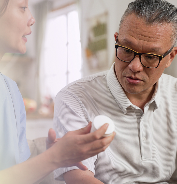 A pharmacist talking a patient through how to use a topical treatment
